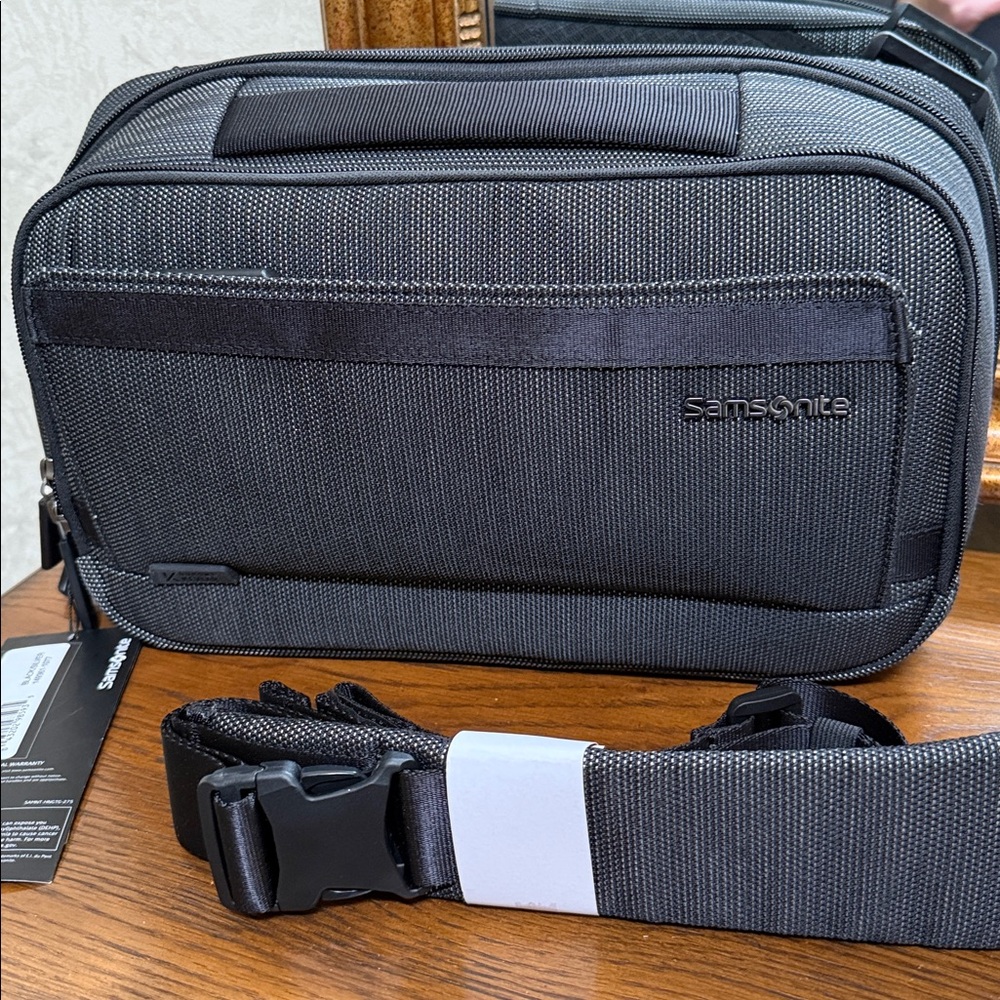 Samsonite Convertible sling bag-Adjustable/removeable strap. 4 Zip storage areas